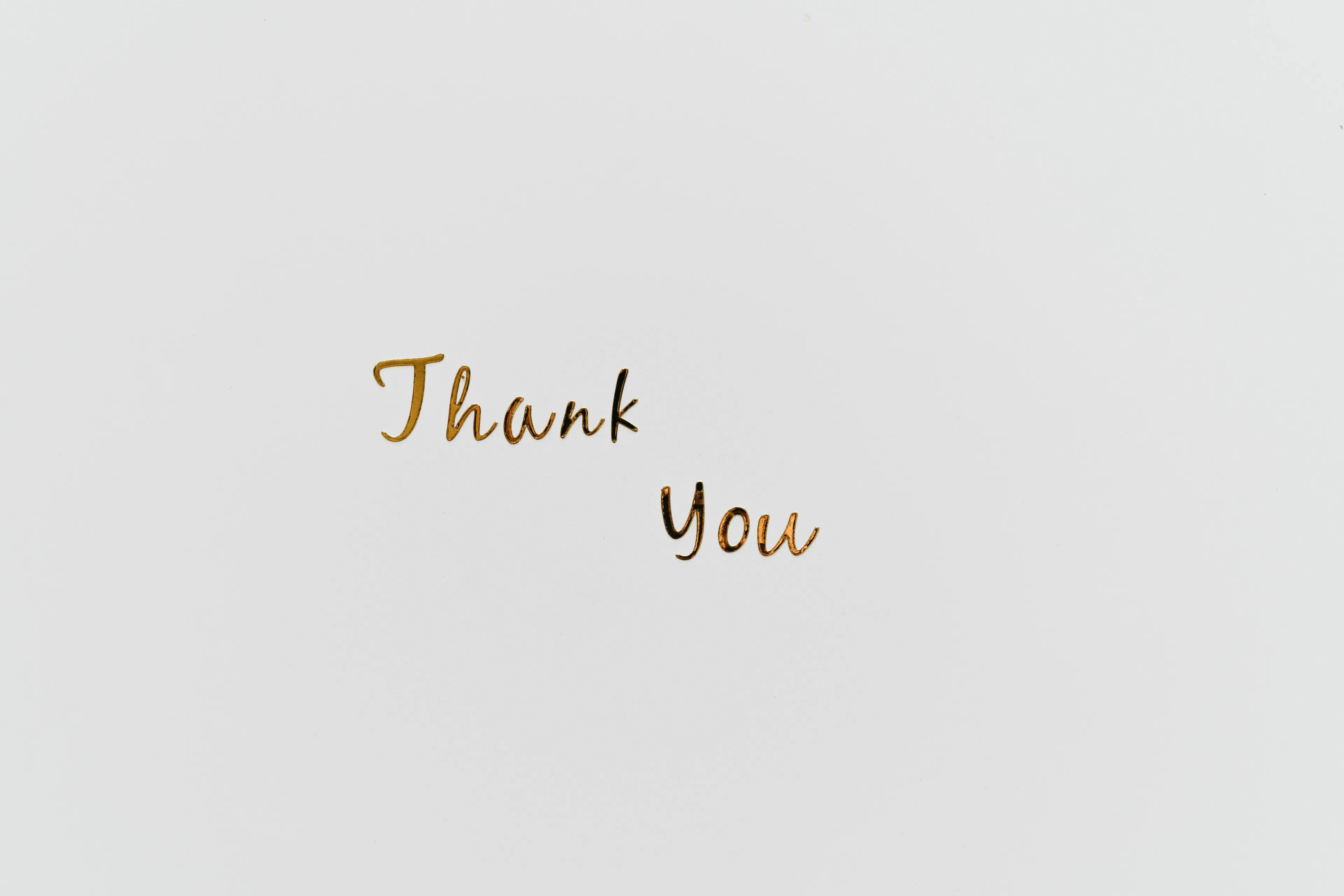 The words Thank You in elegant gold script on a white background, showing appreciation for a green flag.