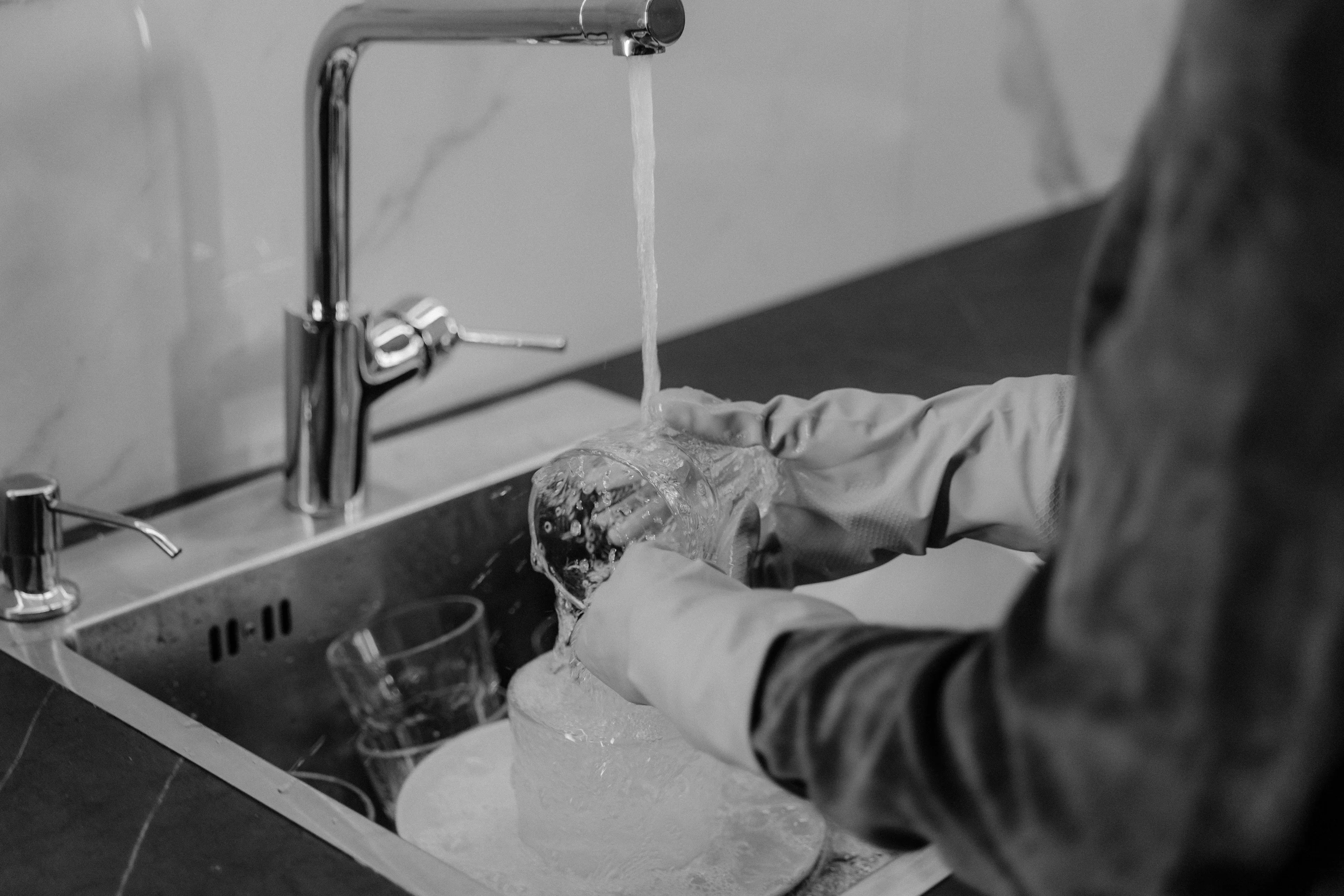 A person washing dishes, a green flag for a good roommate.