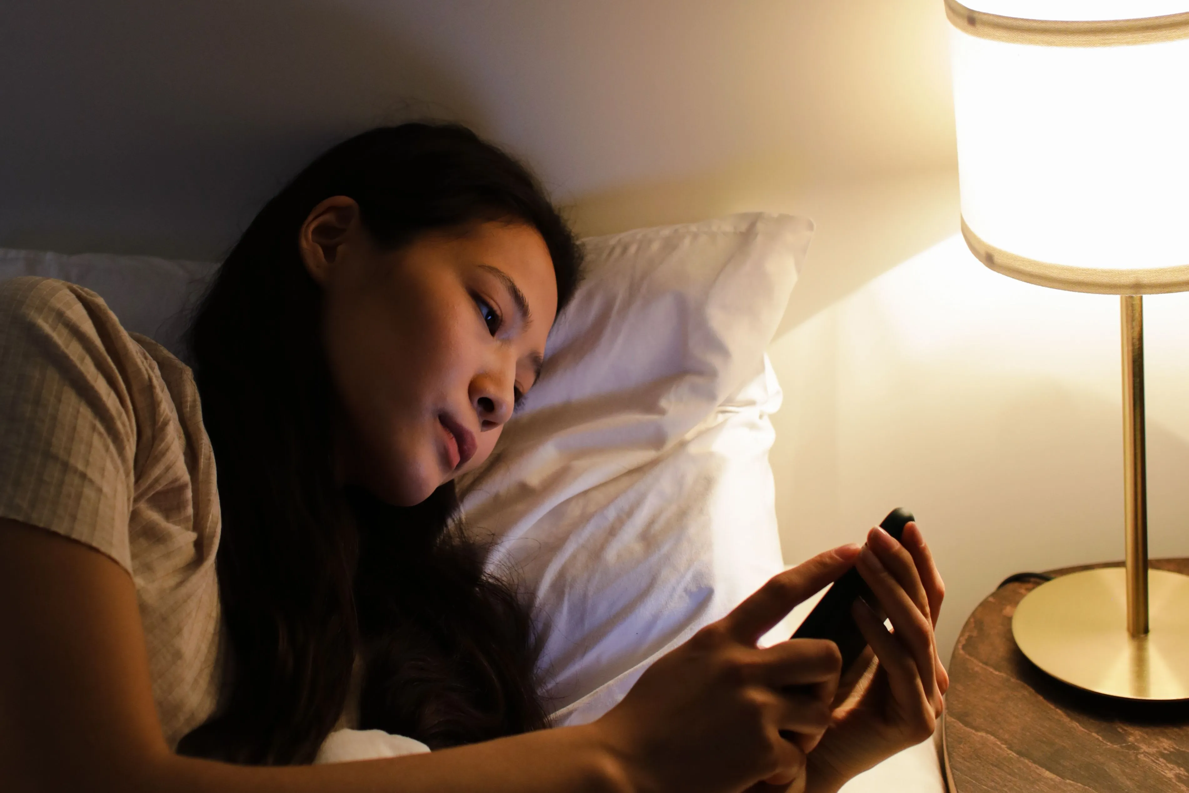 A woman checking in on someone she loves on her phone before bed most nights.