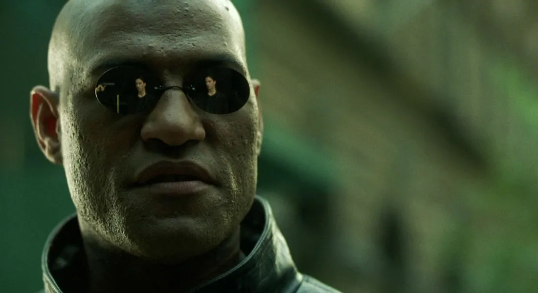Morpheus, a fictional mentor, wearing sunglasses with reflections of other characters, exuding intensity.