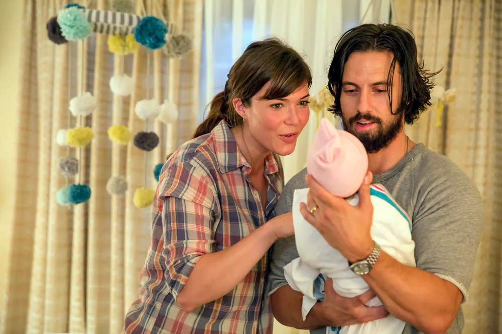 Mandy Moore and Milo Ventimiglia with a baby from This Is Us, picking a comfort show.