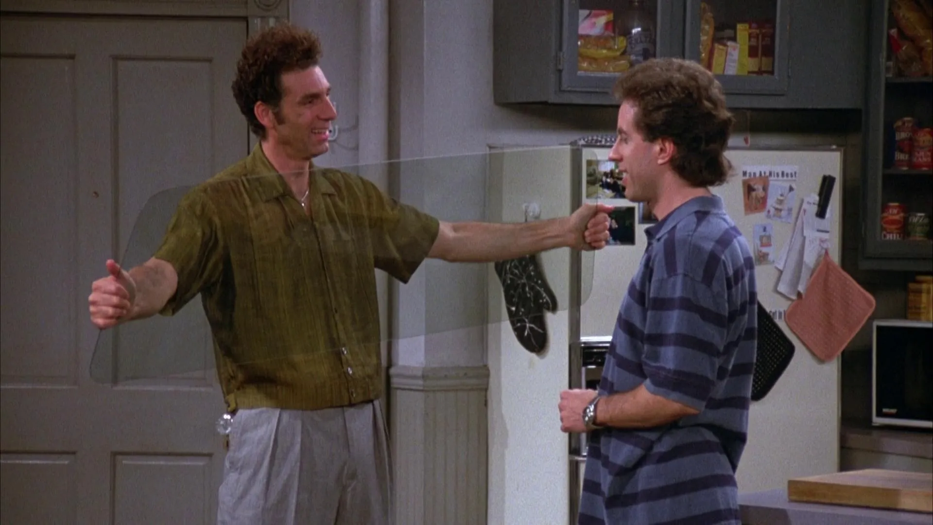 Kramer and Jerry from Seinfeld on a comfort show, holding a string between them, in a kitchen.