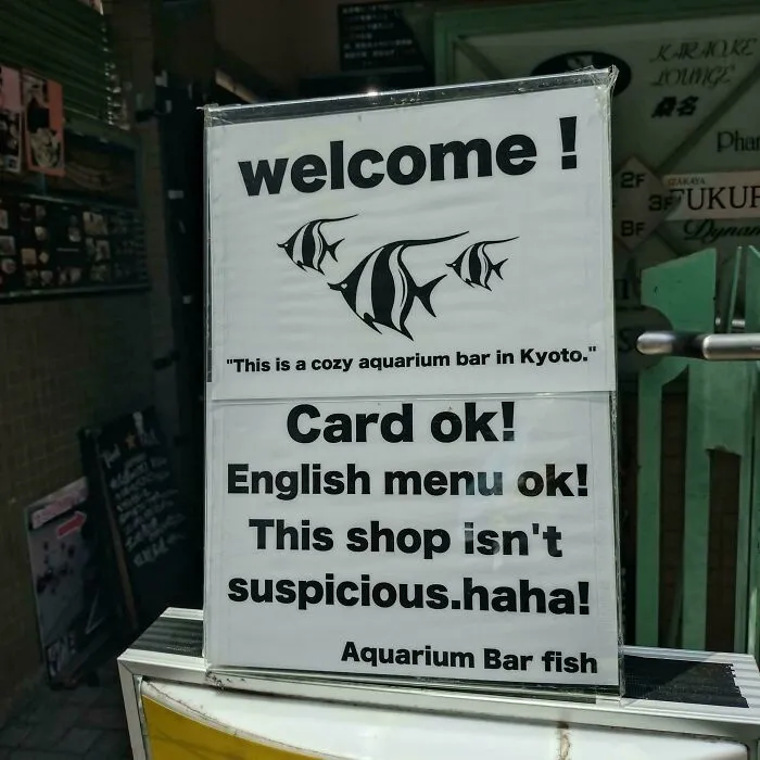 An oddly specific welcome sign for a Kyoto aquarium bar, stating it is not suspicious.