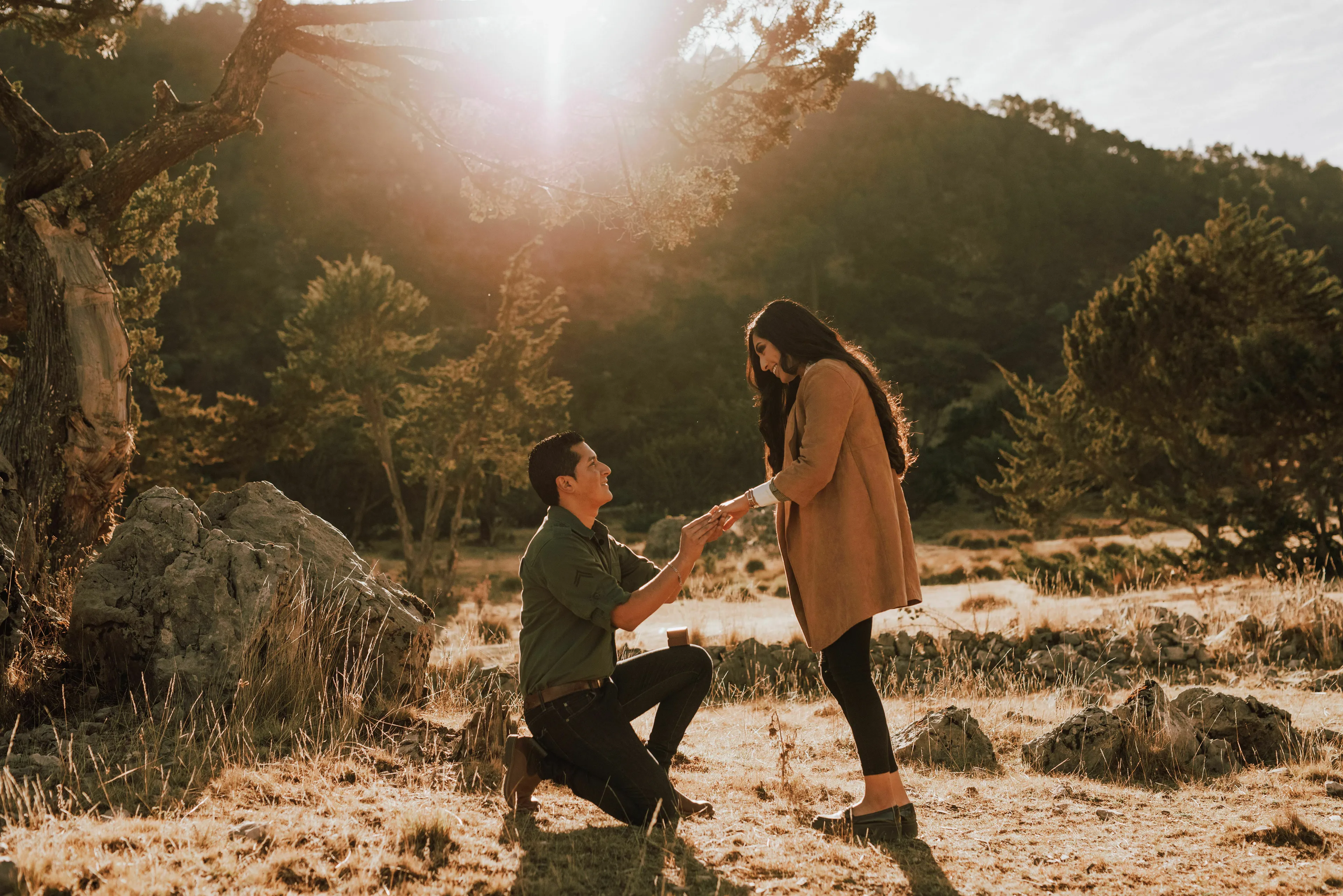 What triggers your envy? A man proposing to a woman outdoors, reminiscent of a classmate's engagement post.