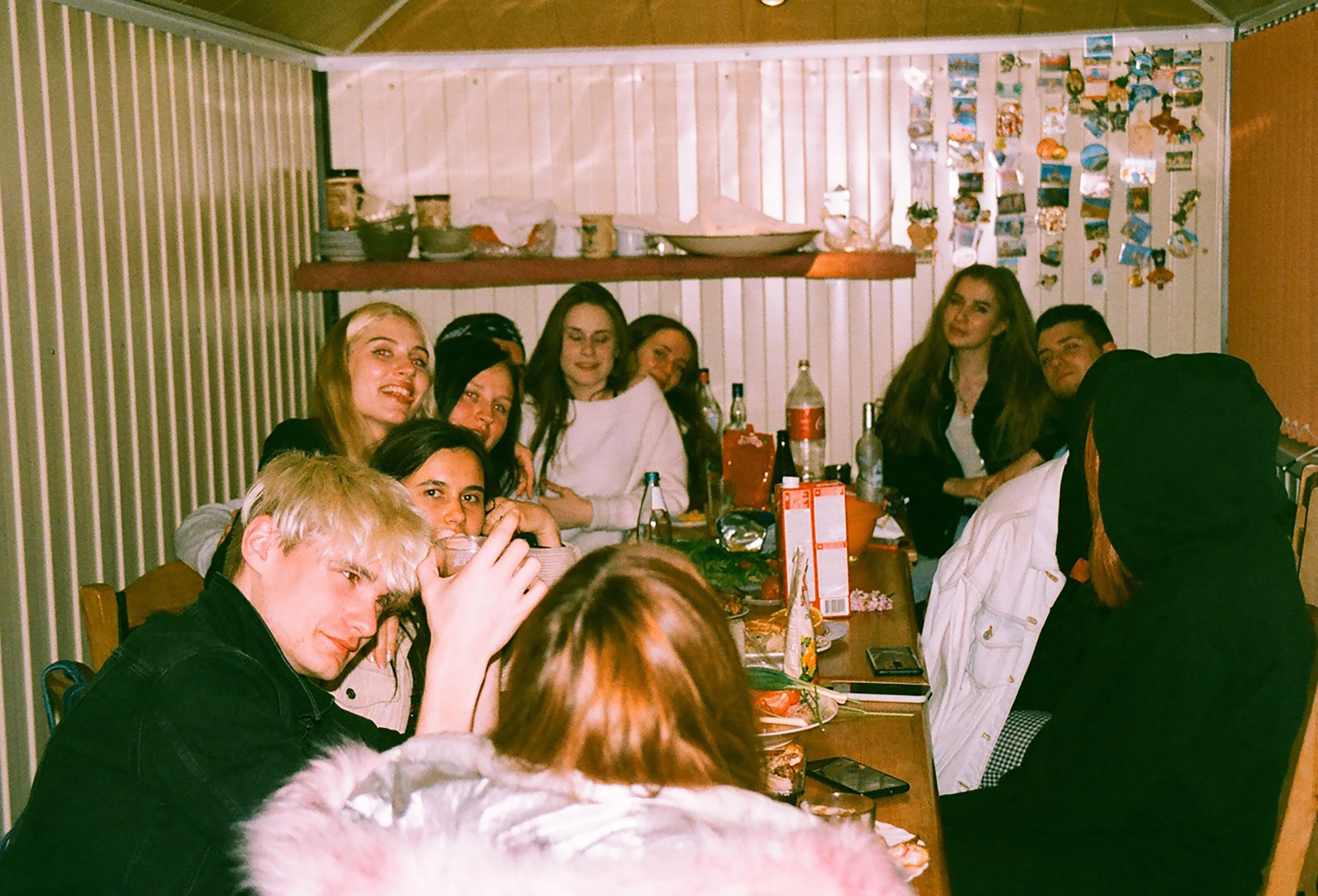 A group of friends at a party, prompting thoughts on the real reason one would skip a friend's party.