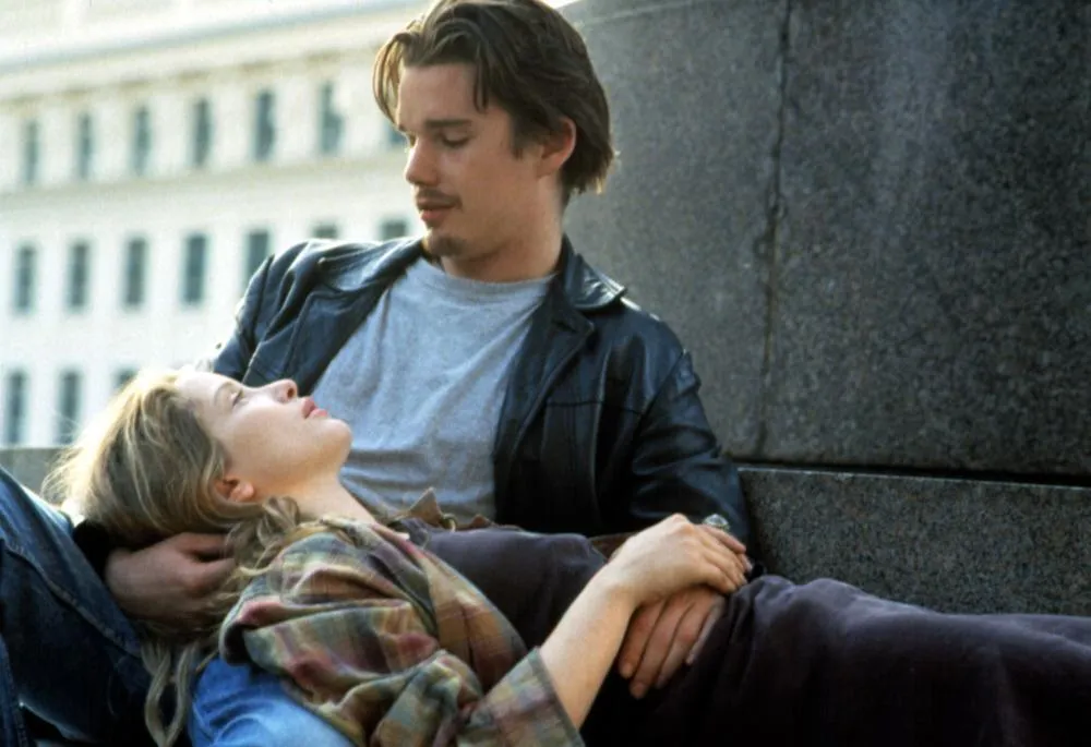 A romantic moment from Before Sunrise, with a man and woman embracing outdoors on a lazy Sunday.