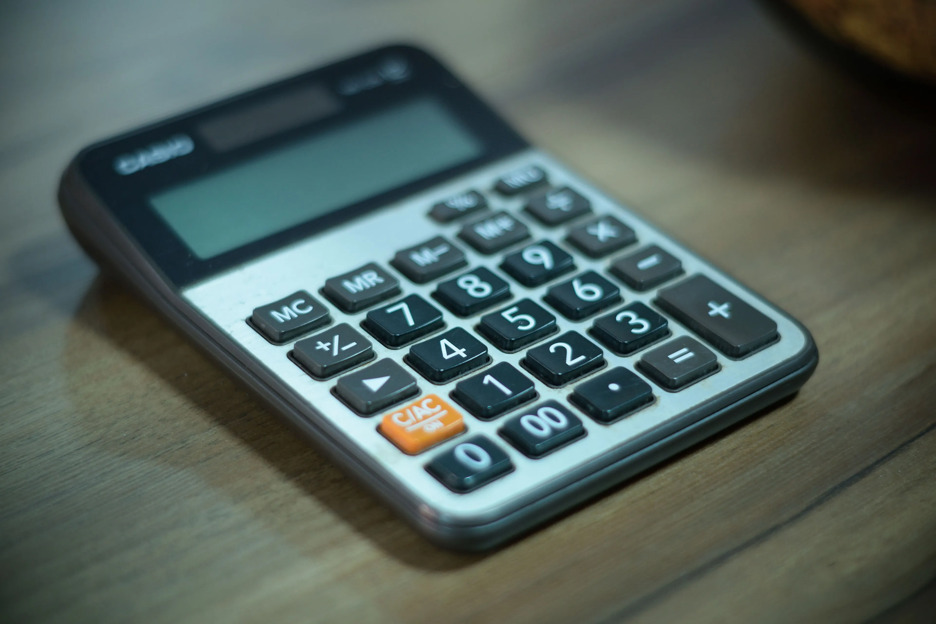 Calculator on a wooden desk, symbolizing the school subject Math and a competitive streak.