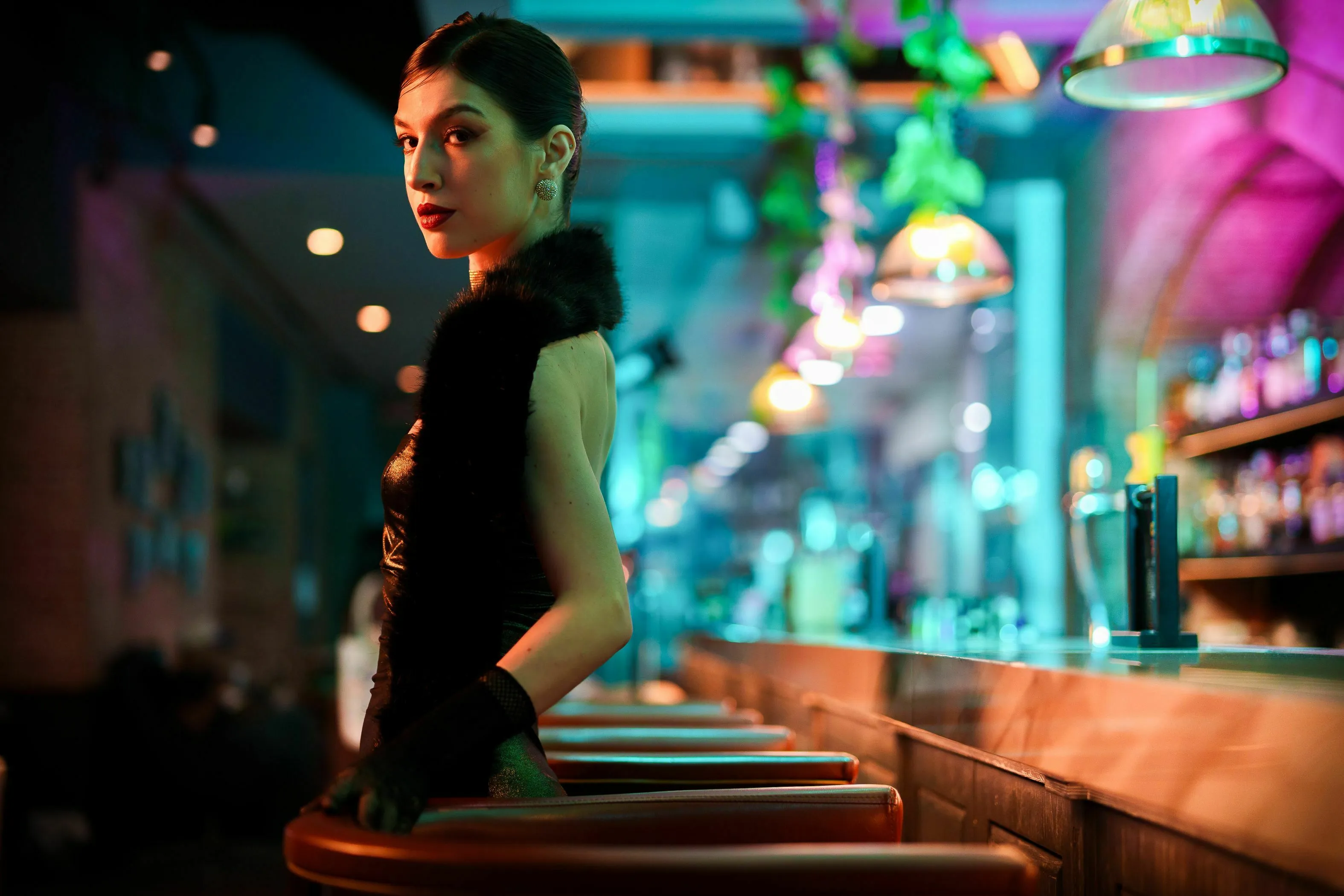 Elegant woman in a bar, wondering which decade she was born to live in for a big night out.