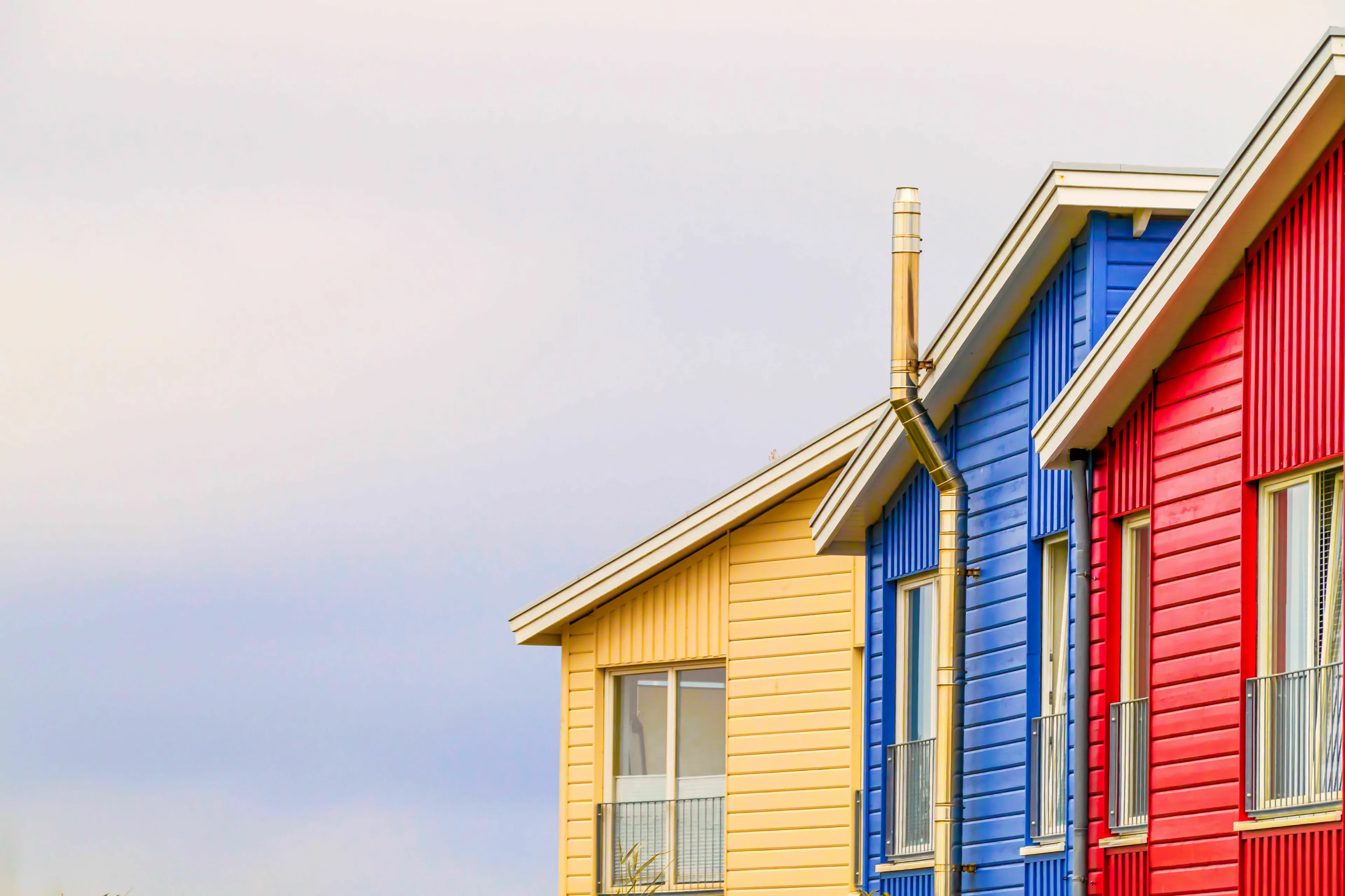 Colorful yellow, blue, and red houses, illustrating an ideal home vibe for your born decade.