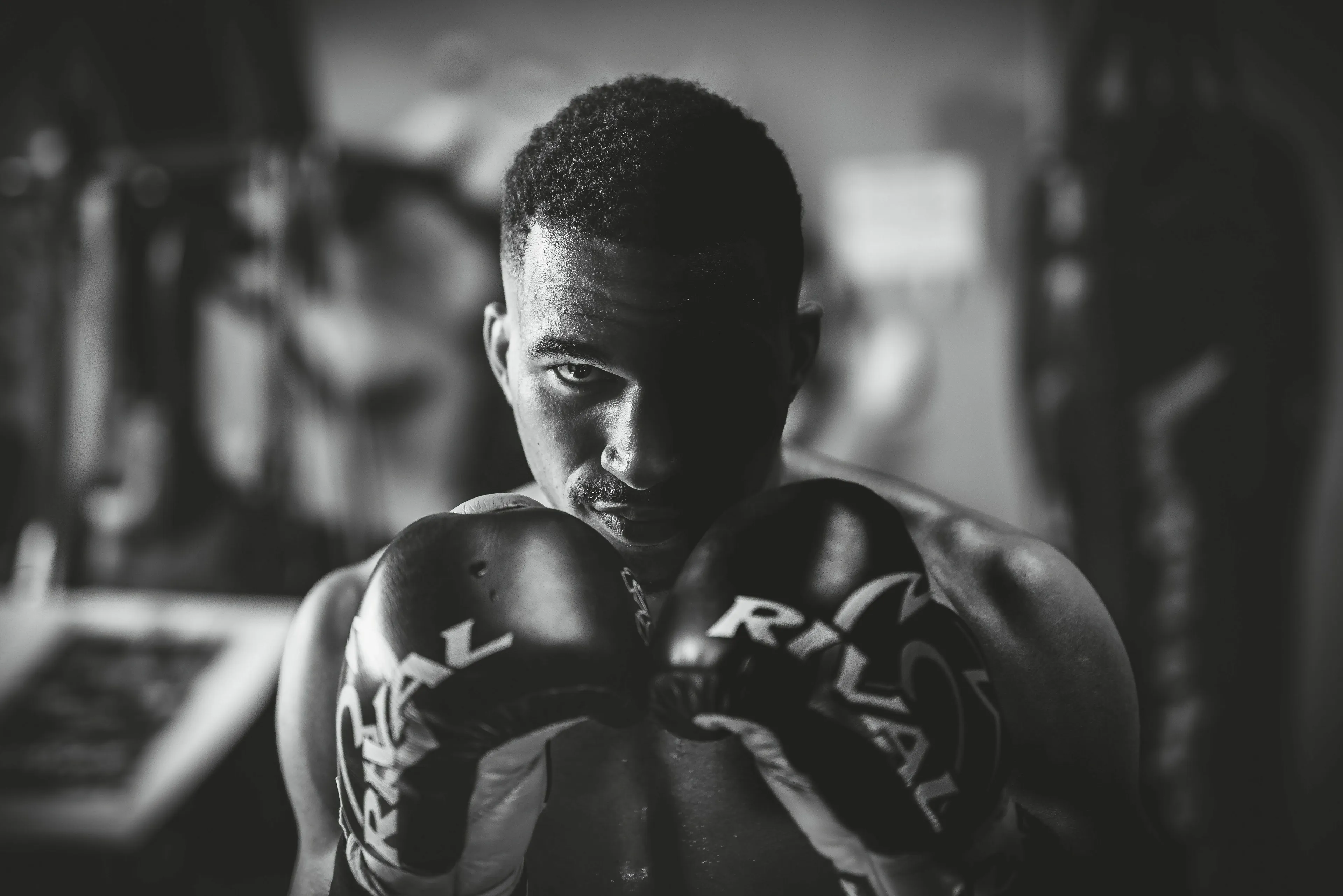Historical figure, a focused boxer, prepares to handle a rival who is clearly better connected.