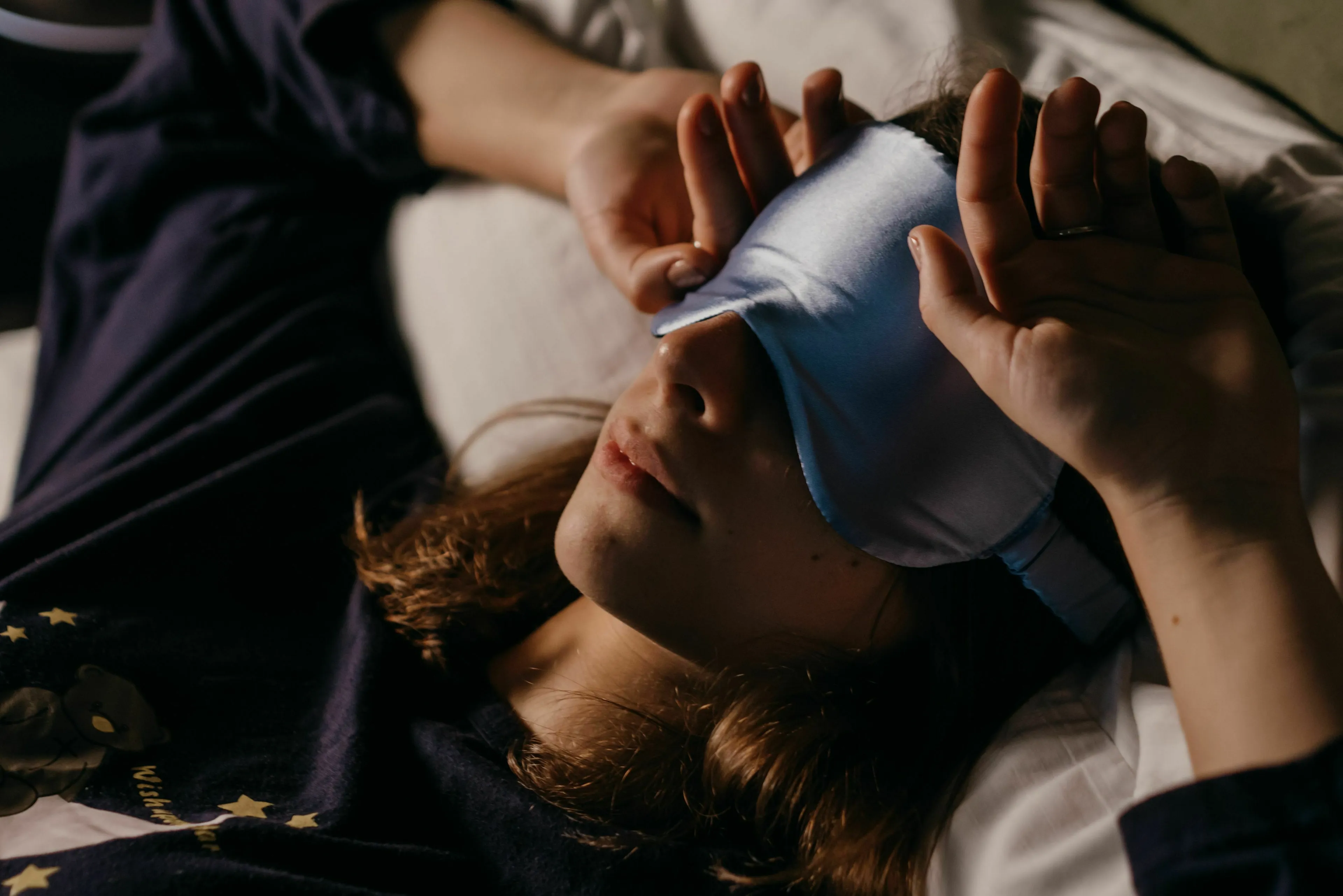 A person in bed wearing a sleep mask. What keeps you up at night? A quiz to find out which historical figure you are like.