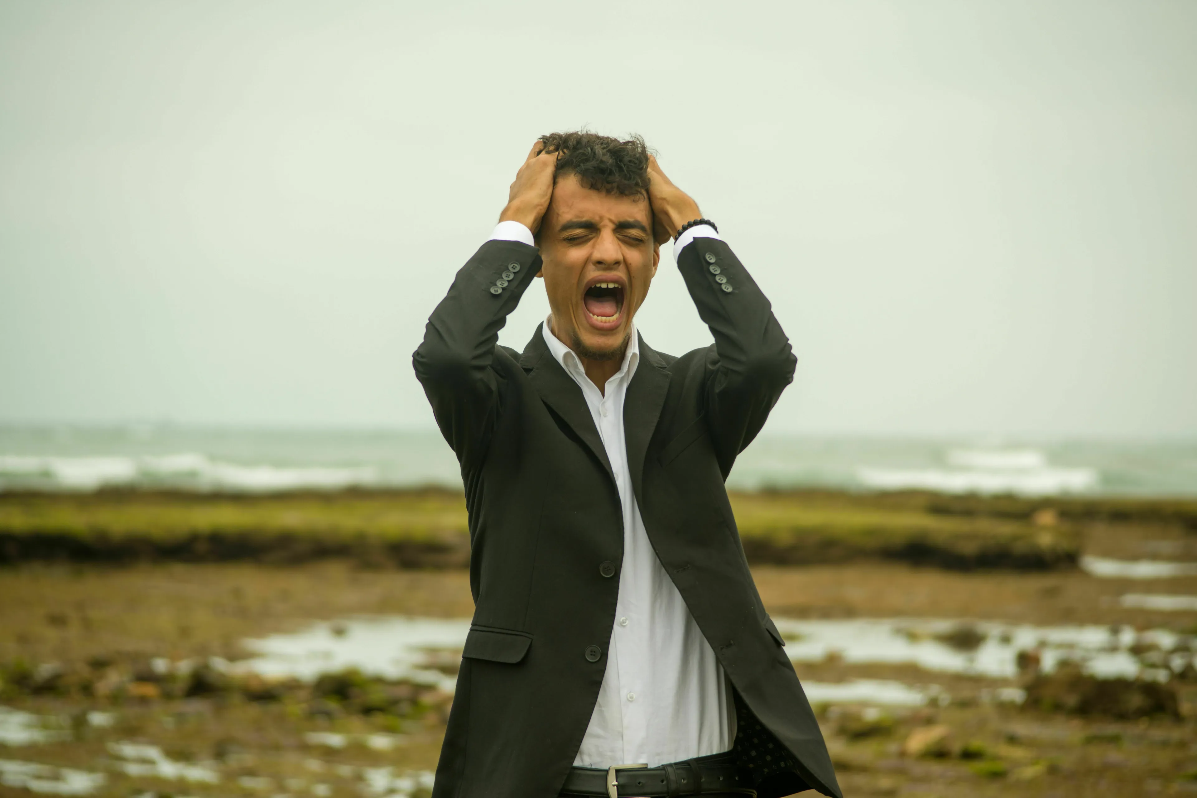 A man screams in frustration on a beach, showing what frustrates a historical figure most in other people.