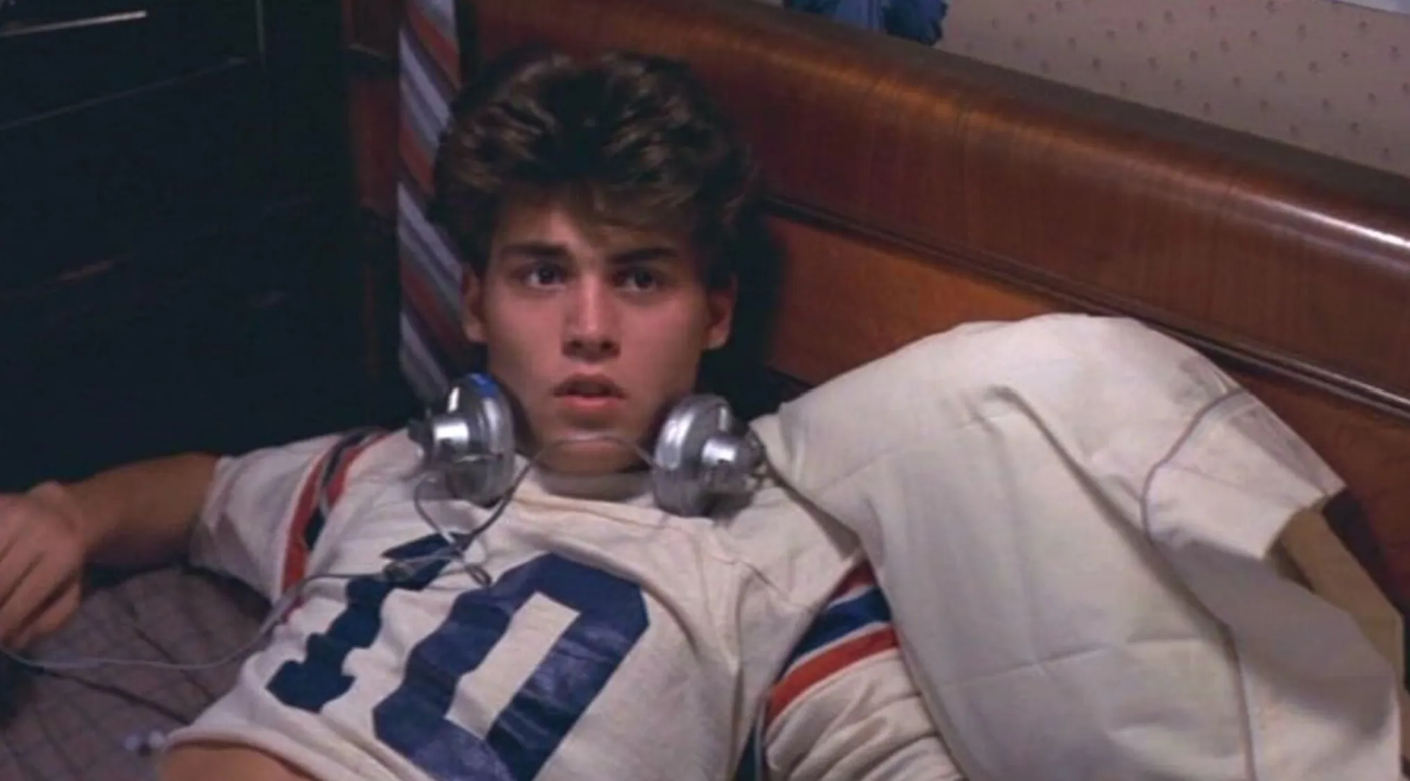 Young Johnny Depp with headphones around his neck, before his film debut and fame.