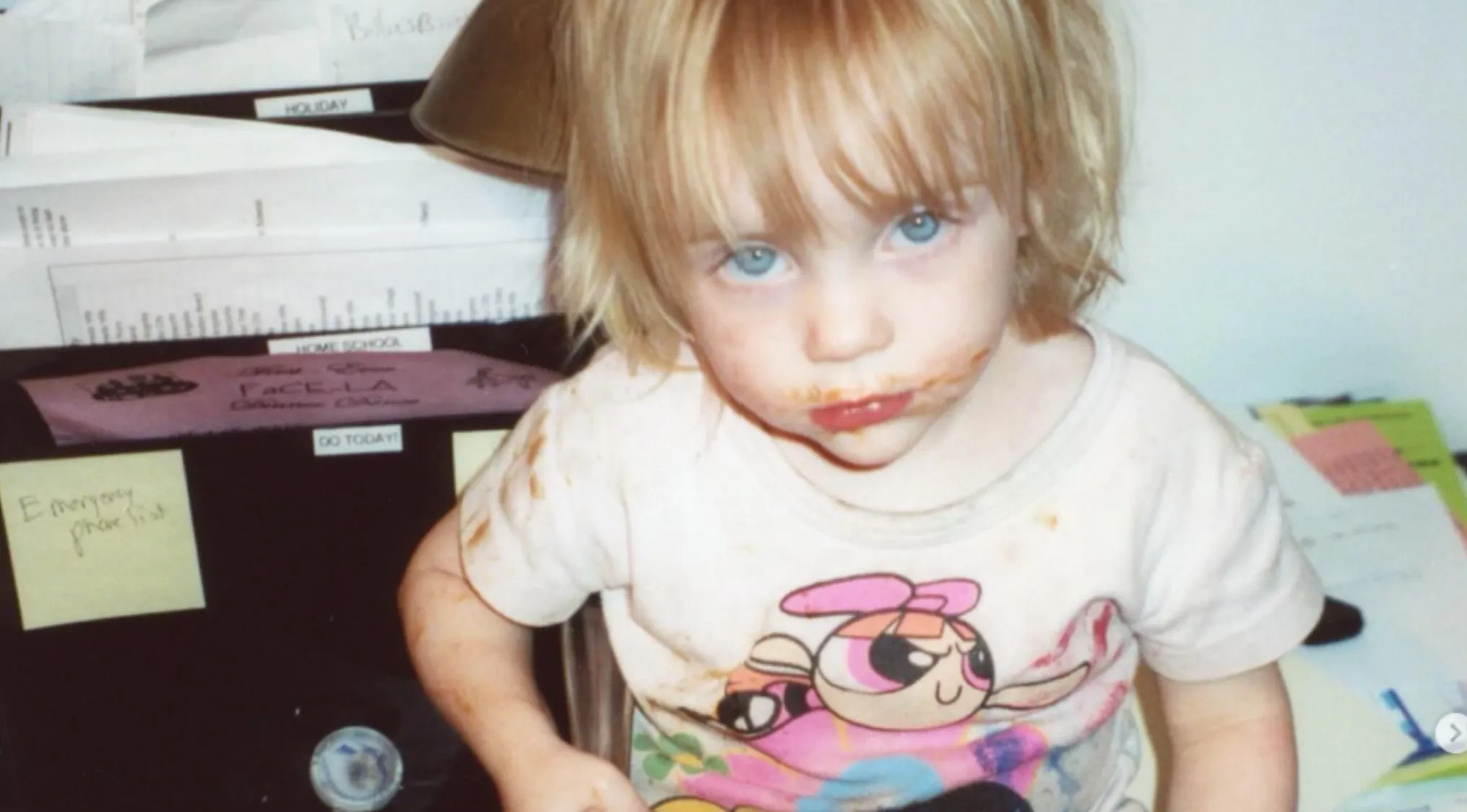 A young, messy-faced child with blonde hair, who will become a rising star and famous person.