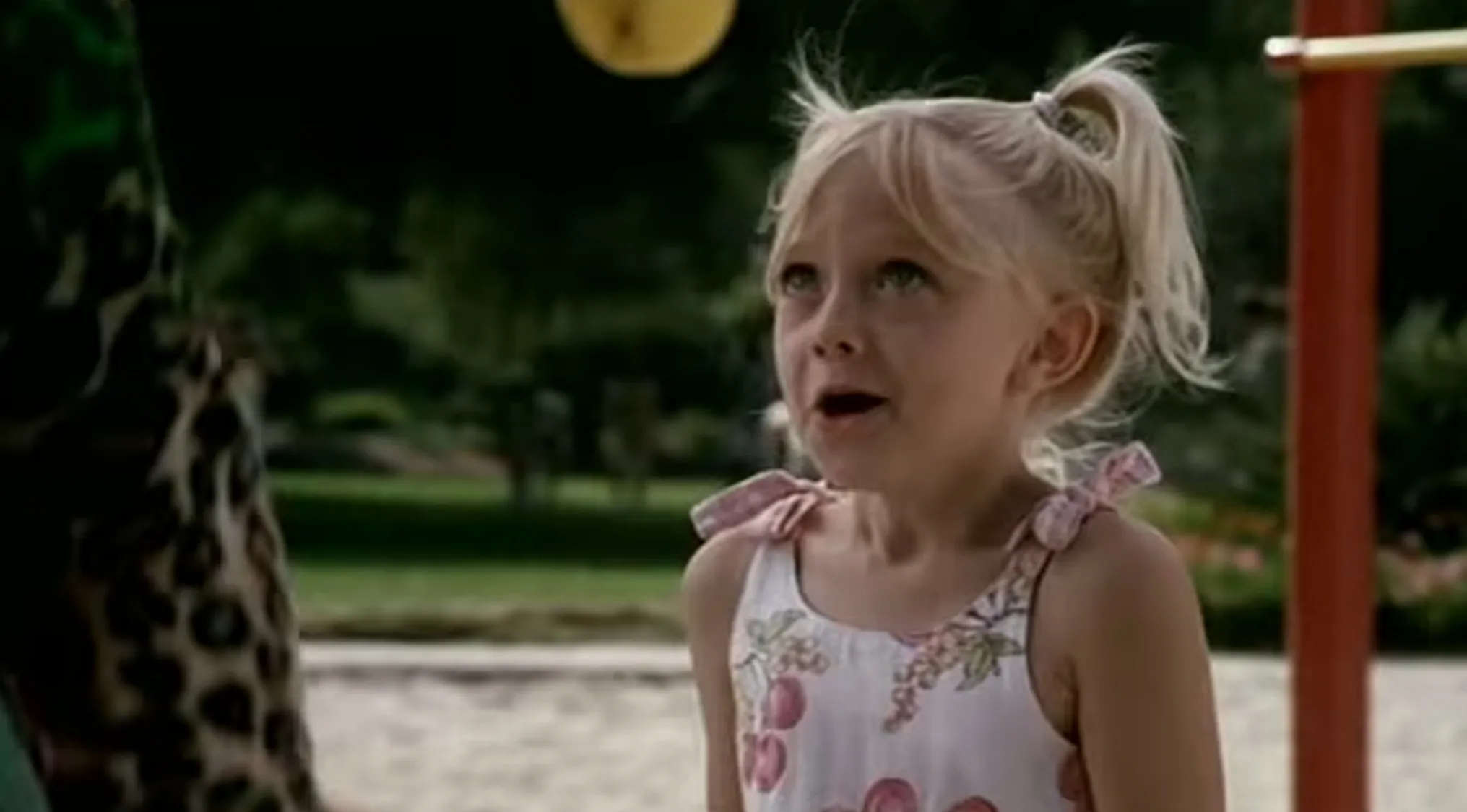 Young Dakota Fanning with pigtails. Famous people before the fame, recognize the star.