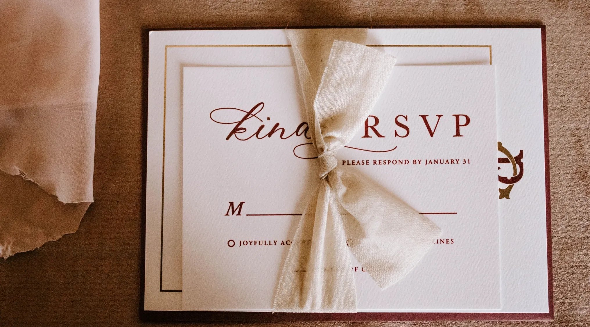 A formal invitation tied with a beige ribbon, with "RSVP" and a response deadline. Home Economics.