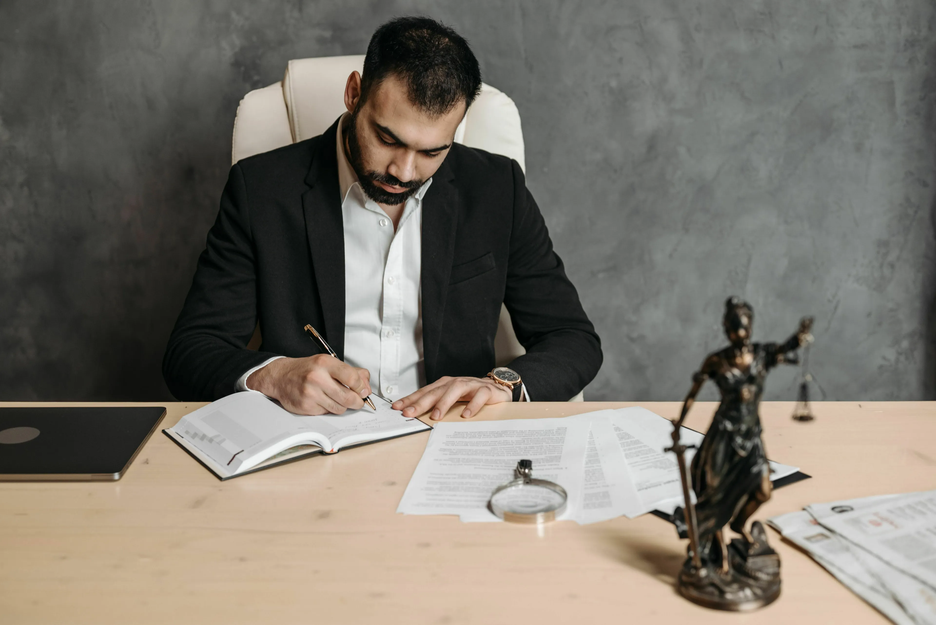 A legal professional offering advice at a desk, with a scale of justice, for the American vs English Words Quiz.