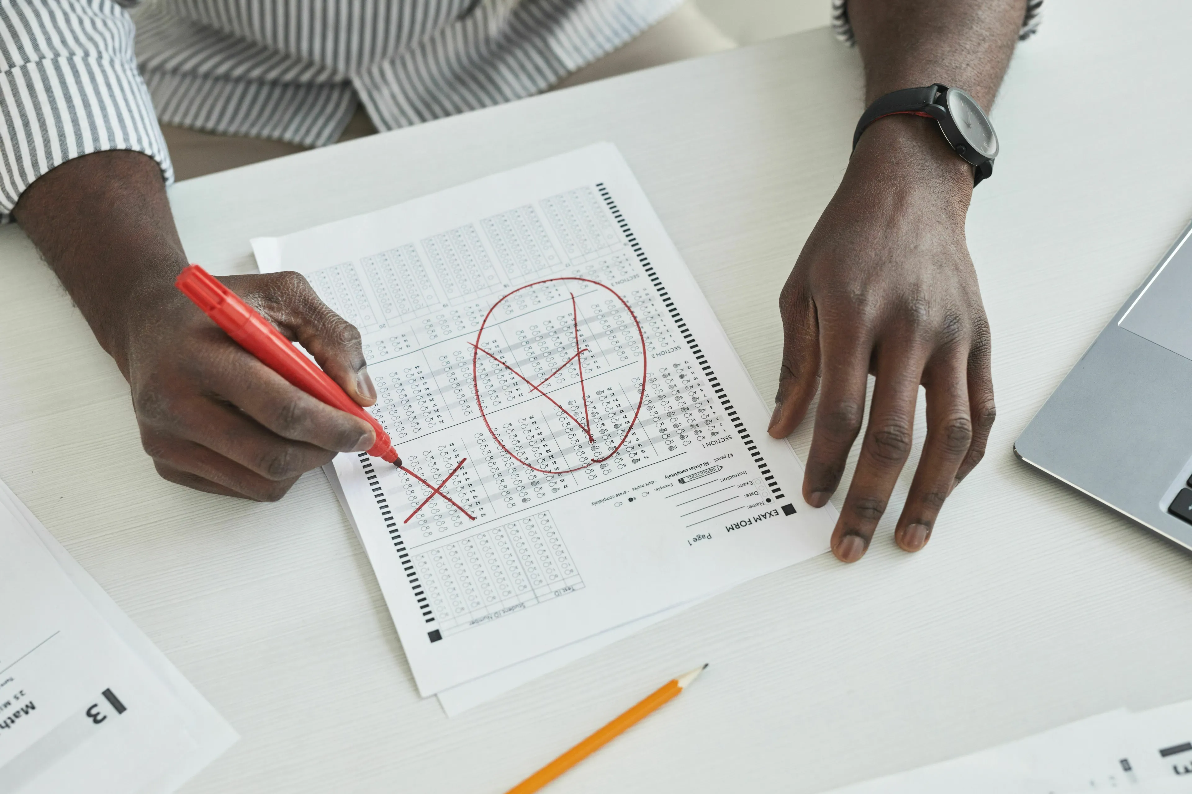 British vs American words quiz showing a student correcting an exam paper with red marks.