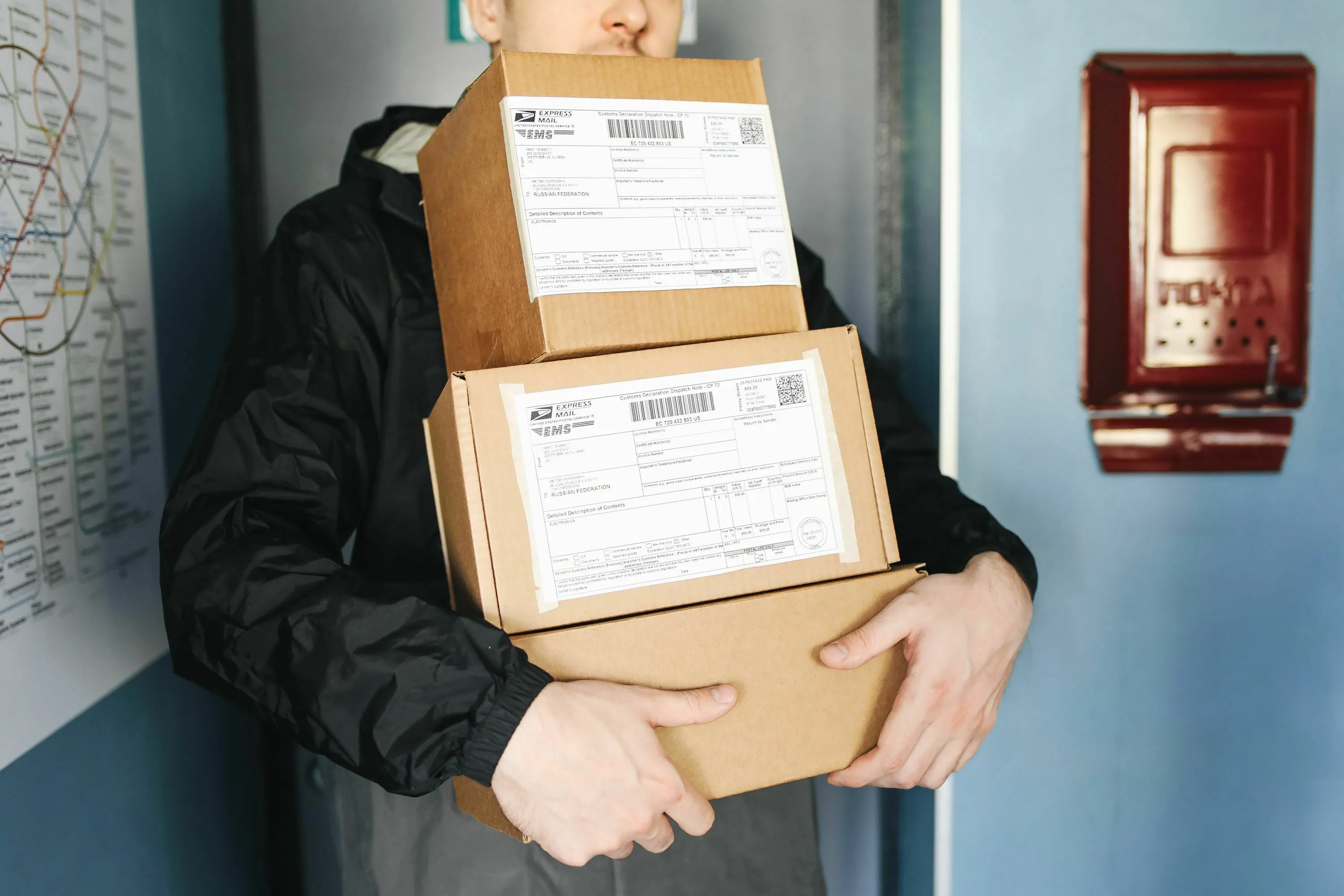 A person holding several shipping boxes, relevant to an English words quiz about sending and receiving.
