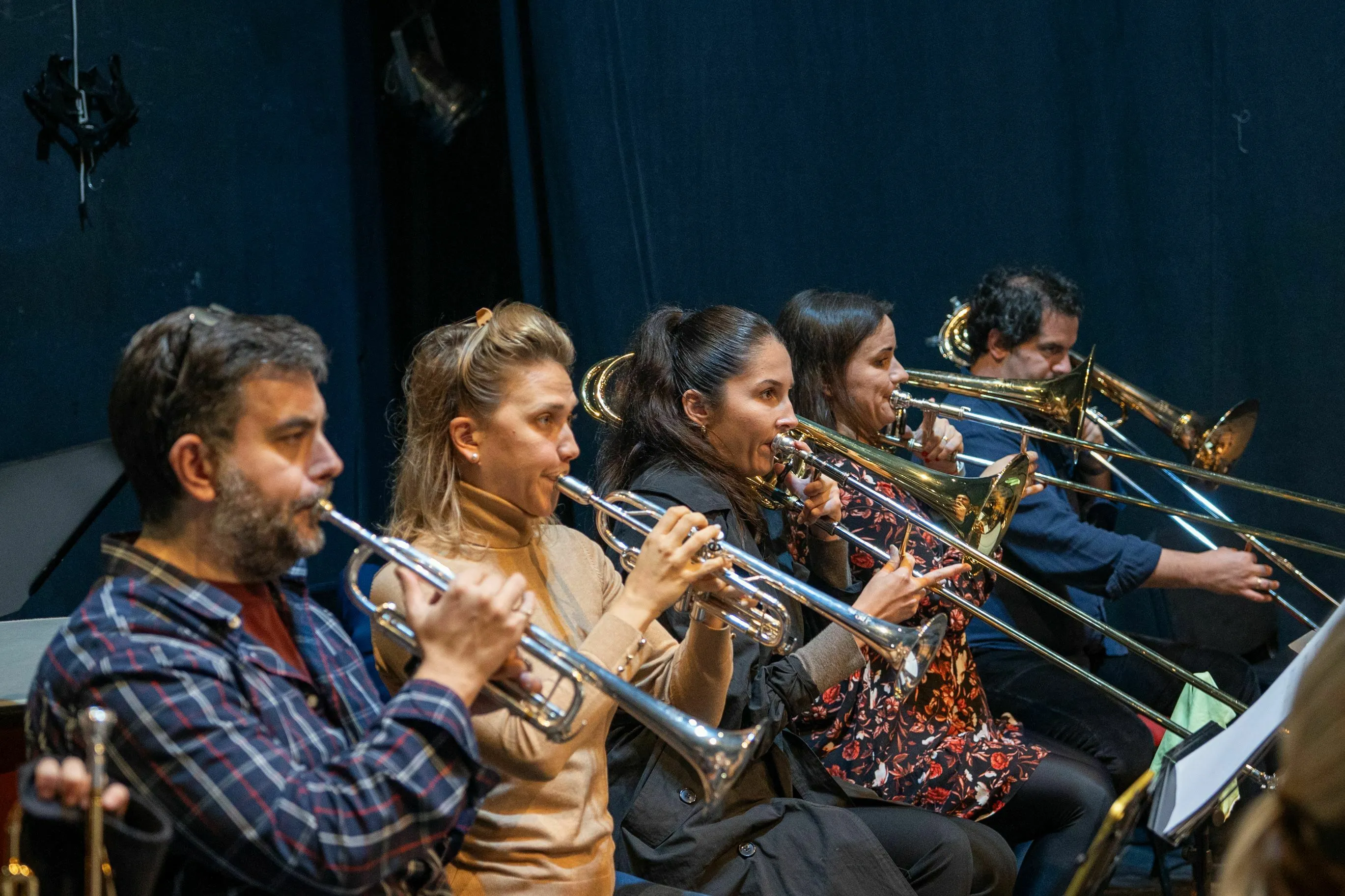Classical Music Quiz: musicians playing brass instruments, including a trombone with a long, sliding tube.