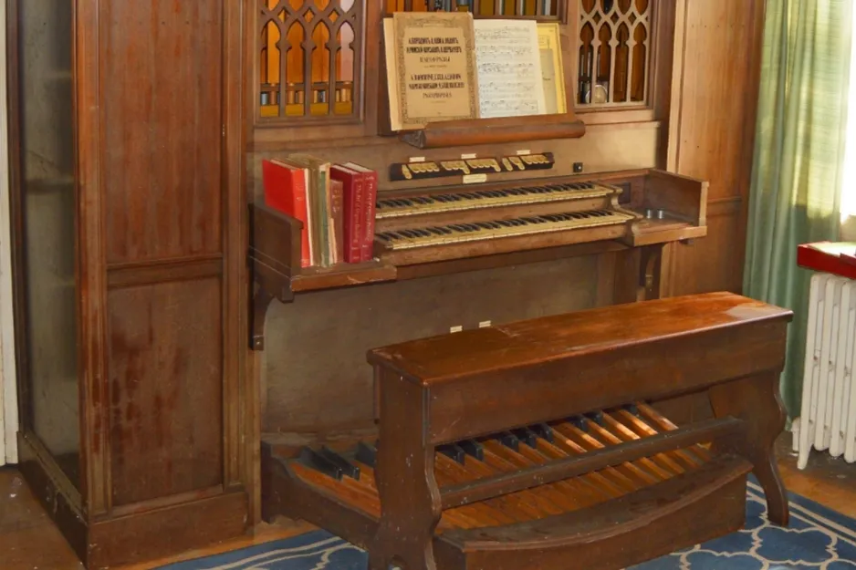 A Pipe organ custom-built to adapt to the architecture, featuring wooden construction and multiple keyboards.