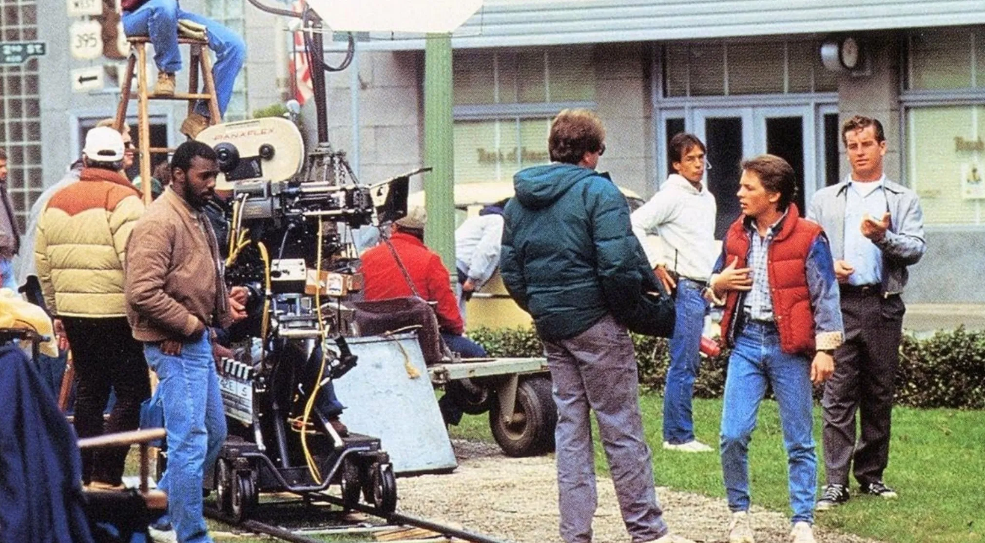 Behind-the-scenes movie image showing the film crew and actors, including one dressed as Marty McFly. Can you guess the movie franchise?