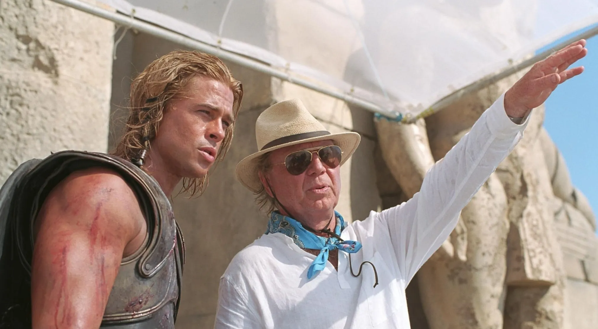 Guess The Movie from this BTS image showing Brad Pitt in costume and a director on set.
