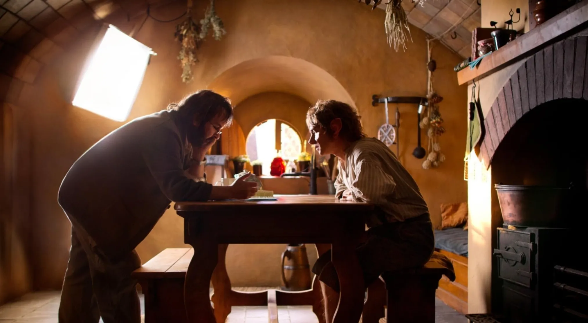 Candid set photo shows director Peter Jackson and Martin Freeman (Bilbo Baggins). Guess the movie from this BTS image!