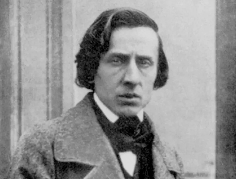 Frédéric Chopin, a renowned composer, depicted in a somber black and white portrait, with a serious expression.