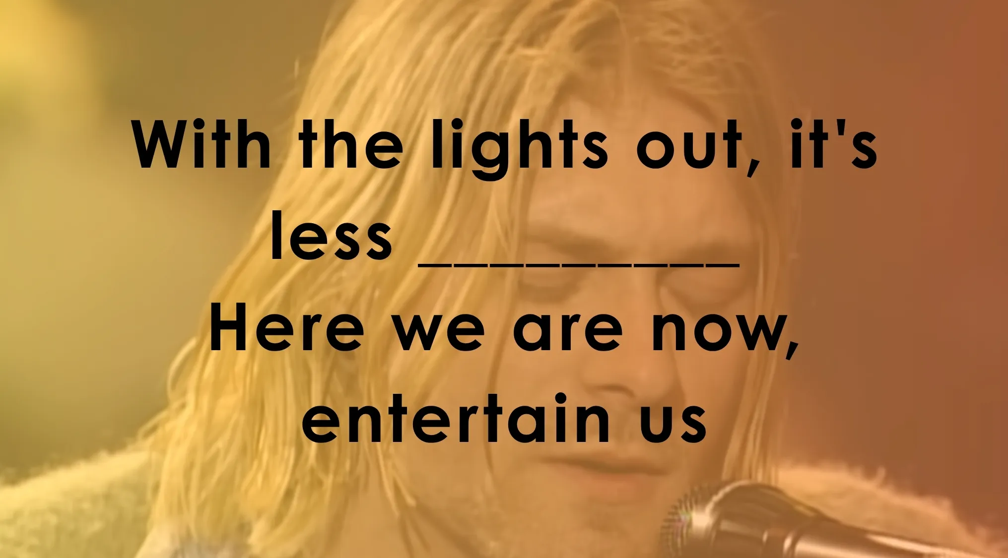 Close-up of Kurt Cobain, with song lyrics displayed, challenging users to finish famous music lyrics by continuing the lyrics.