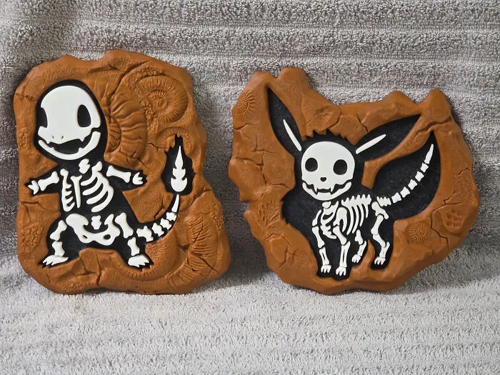 Two Pokemon fossil replicas, Charmander and Eevee, showcasing cool and useful things created with a 3D printer.