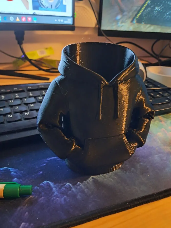 A black 3D printed hoodie-shaped container, cool and useful things created with a 3D printer.