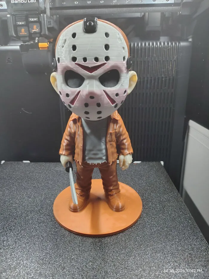 A cute 3D printer creation of a chibi Jason Voorhees figure with a mask and a knife.