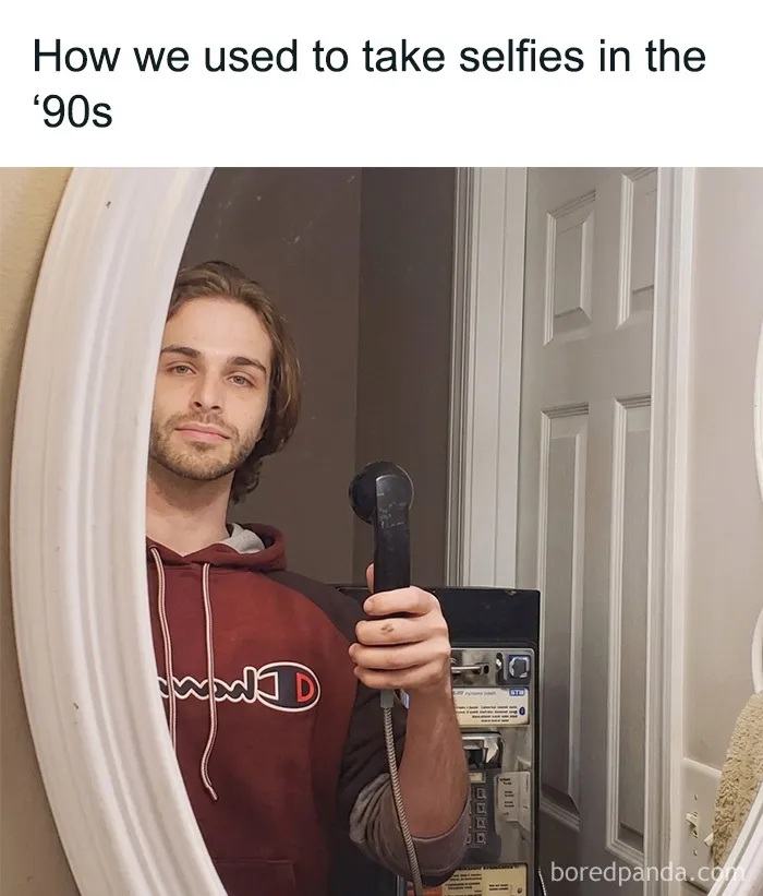 A man takes a mirror selfie with an old corded telephone, a throwback meme for 90s kids.