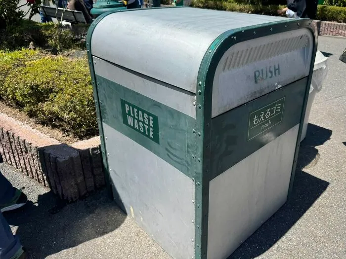 A trash can with the label PLEASE WASTE, an example of getting lost in translation in Japan.