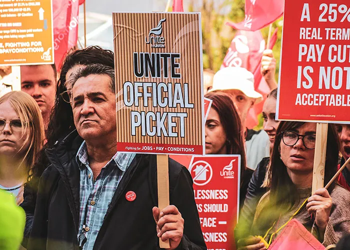 People holding picket signs in a crowd, demonstrating things we slowly stopped doing that worked for older generations.