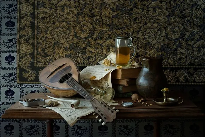 Still life color photo with a mandolin, books, and a tankard of beer, remarkably capturing the world.