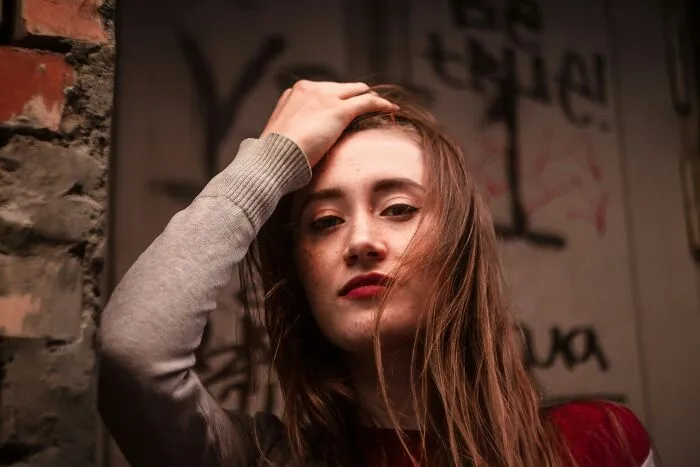 A young woman with an intense gaze, depicting a teen pushing back against under my roof rules.