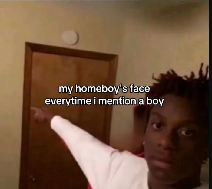 A funny meme of a person pointing, illustrating a friend's reaction every time a boy is mentioned.