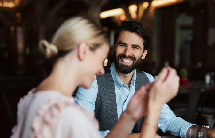 A man smiling warmly at his partner during a conversation, representing partners getting over an ick.