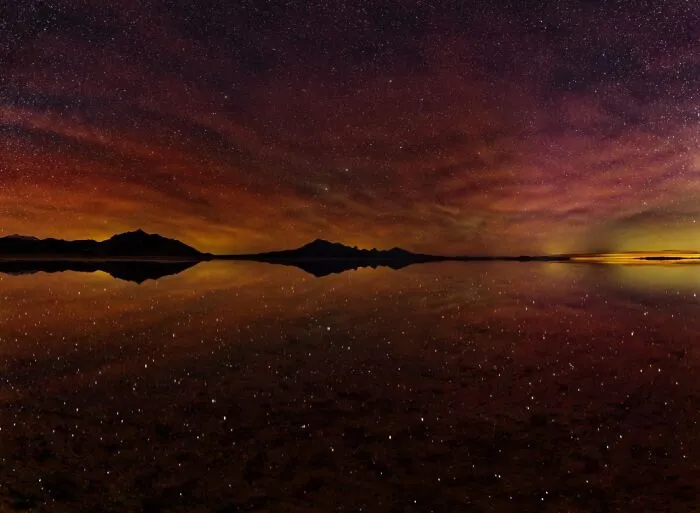Remarkable color photo of a starry night sky reflecting over still water, capturing the world's beauty.
