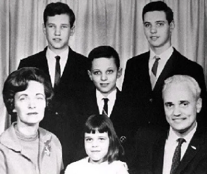 A black and white photograph of a family of six, three adult males, a young boy, a young girl, and an adult woman, connected to unsolved mysteries.