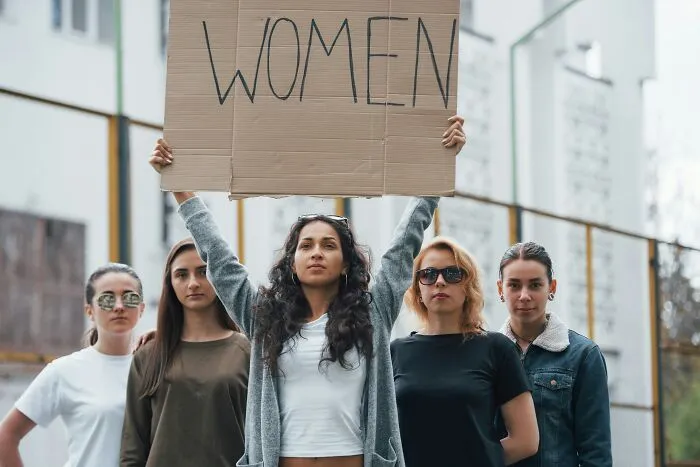 Group of women protesting, advocating for womens rights and changing views and understanding.