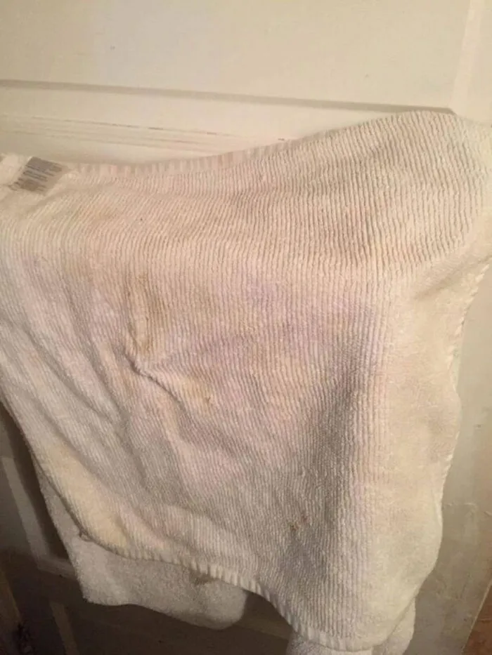 A close-up image of a dirty, stained white towel, an example of common Airbnb blunders.