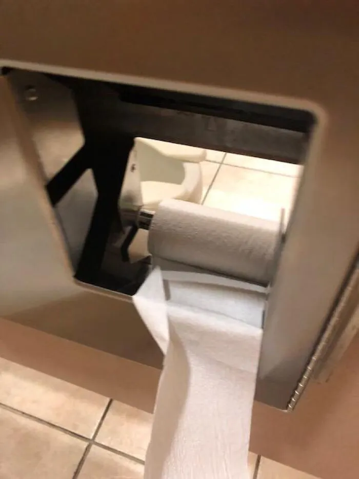 There's A Hole Between Stalls In This Bathroom