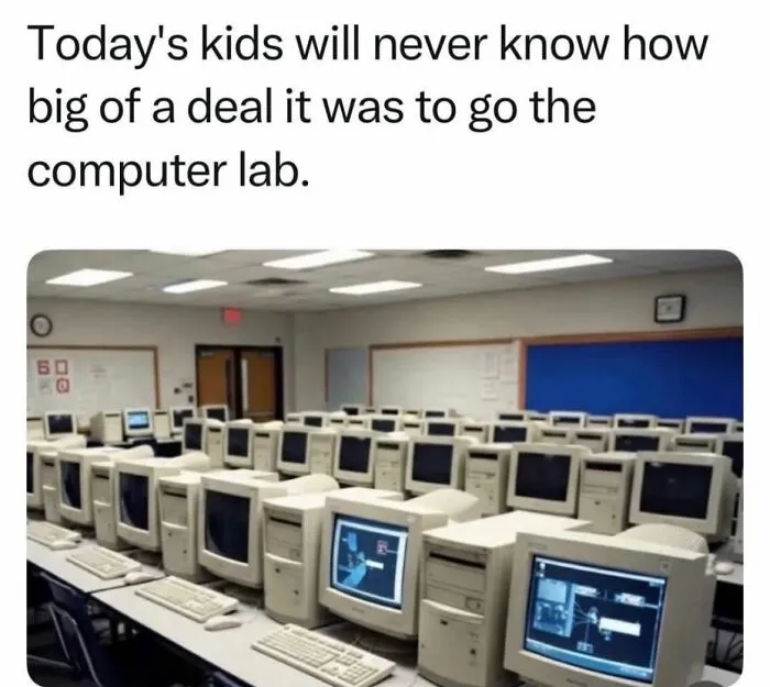 A classroom filled with old computer monitors and keyboards, a memorable Gen X computer lab experience.