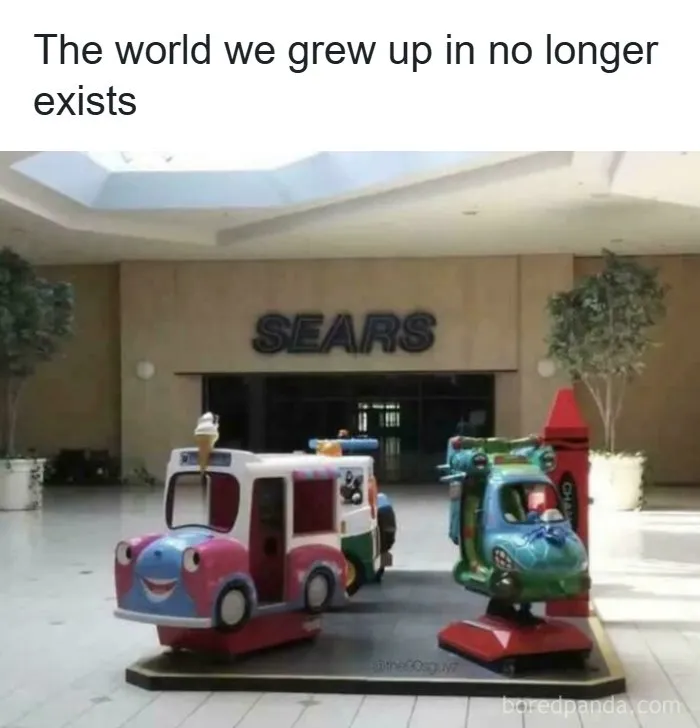 An old Sears store in a mall with children's rides, evoking nostalgia for life in the 90s.