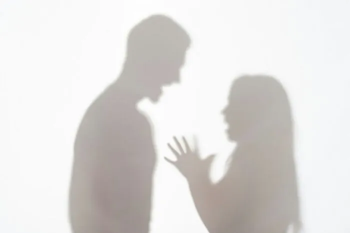 Silhouettes of a couple arguing, depicting the harsh realities of being married.