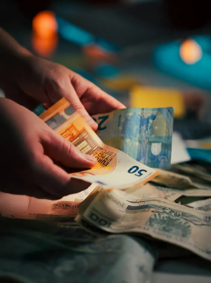 Hands counting money, potentially related to financial issues with entitled friends.