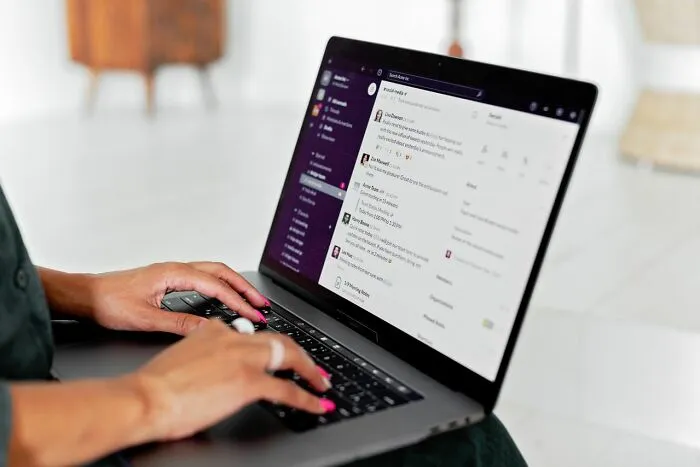 Someone typing on a laptop, using communication software, revealing behind the scenes company operations.